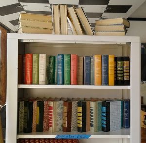 Vintage books repurposed books on shelf in barn