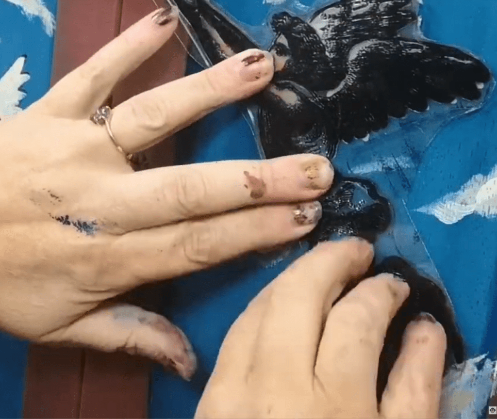 Lel's hands re-stamping the right angel